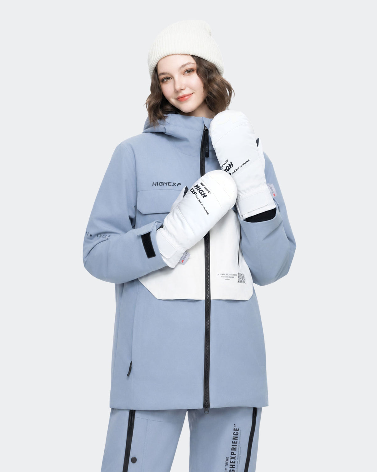 Model wearing HIGH EXPERIENCE ski gloves and a winter jacket for a ski-day emergency clothing checklist