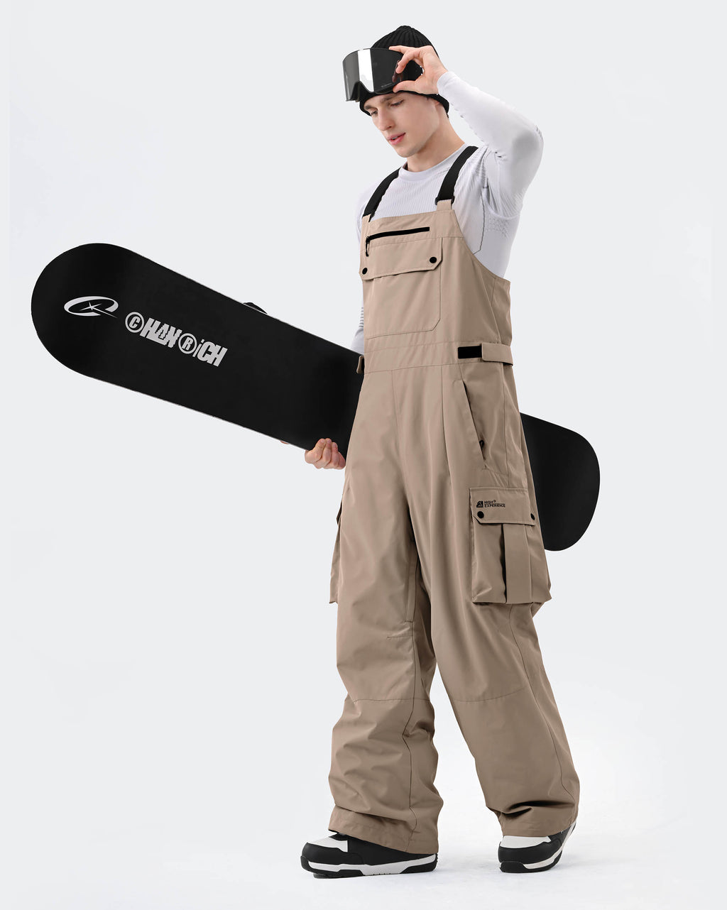 Khaki baggy ski bib pants side view showing relaxed fit
