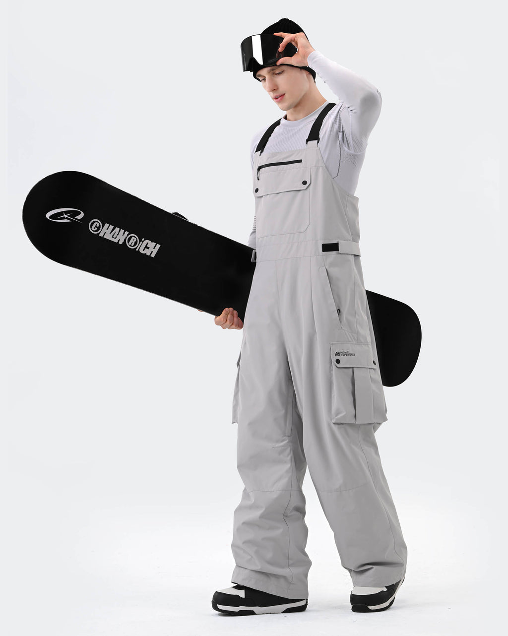 Gray ski bib pants adjustable suspender and snow gaiter detail
