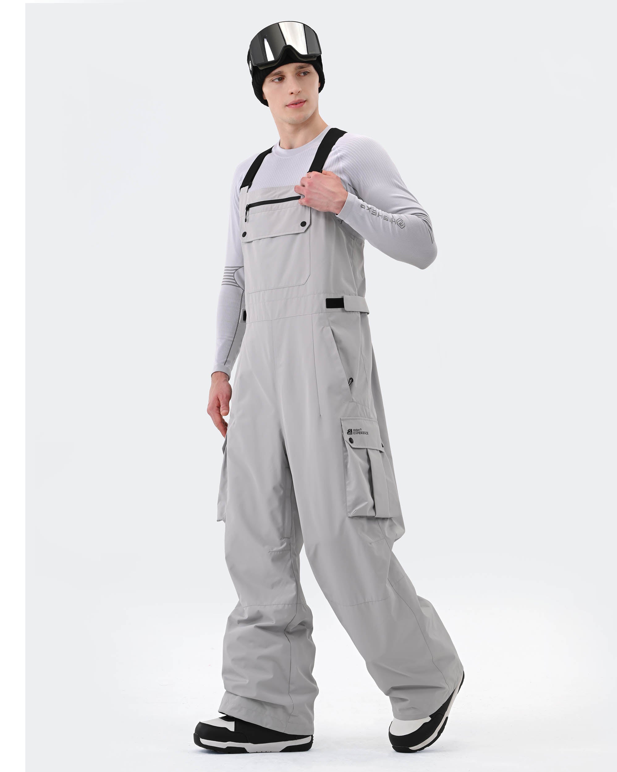 Gray baggy ski bib pants side profile showing generous layering space
