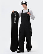 Men wearing Black 3-layer baggy snowboard bibs on slopes

