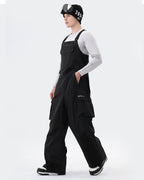 Black baggy ski bib pants side view showing waterproof construction
