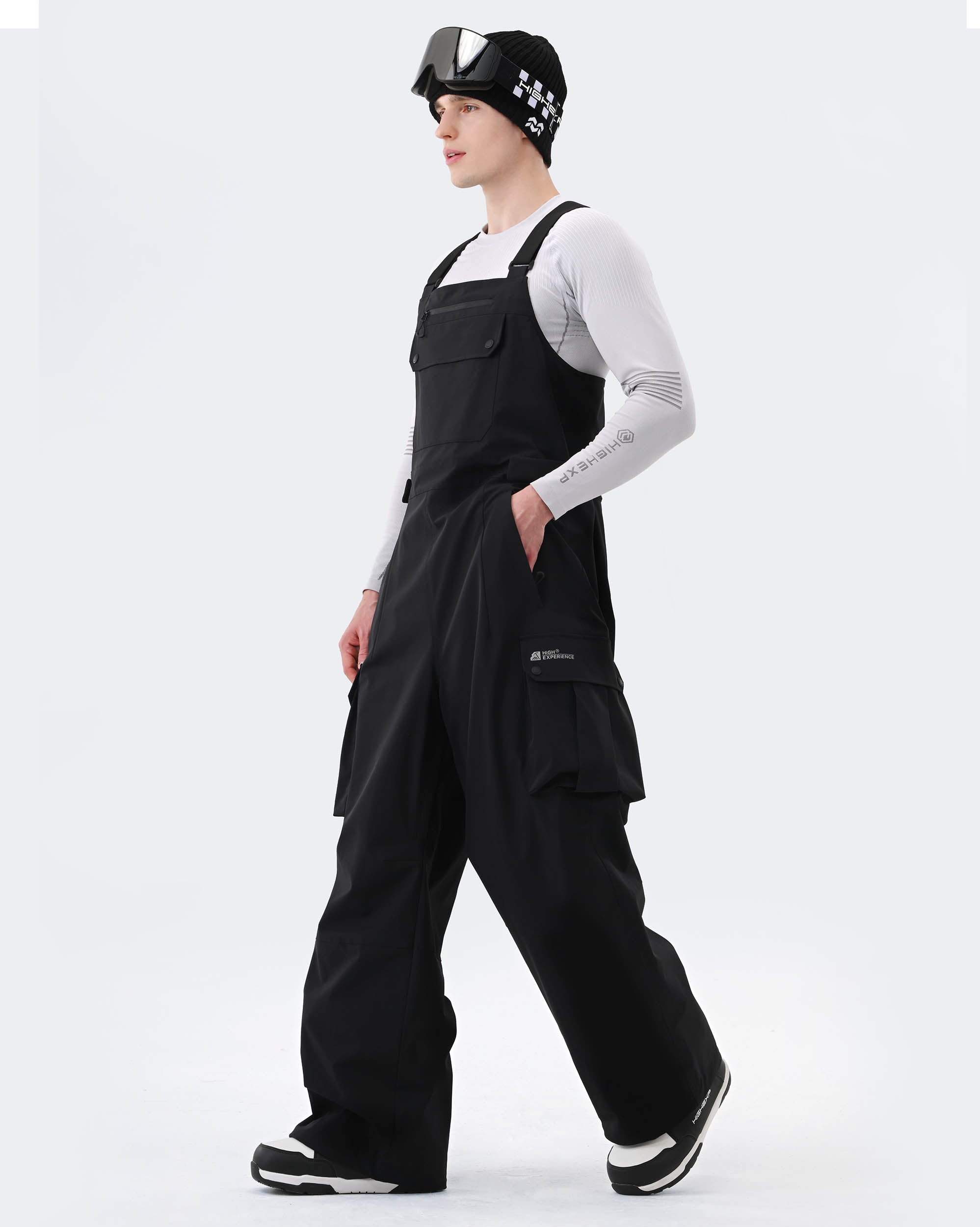 Black baggy ski bib pants side view showing waterproof construction
