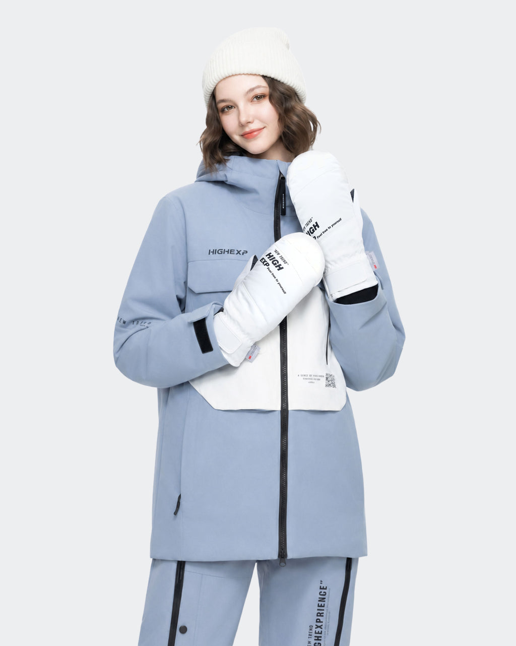 High Experience Black White Ski Gloves - Female Model Wearing Grey Blue Ski Jacket for Winter Sports