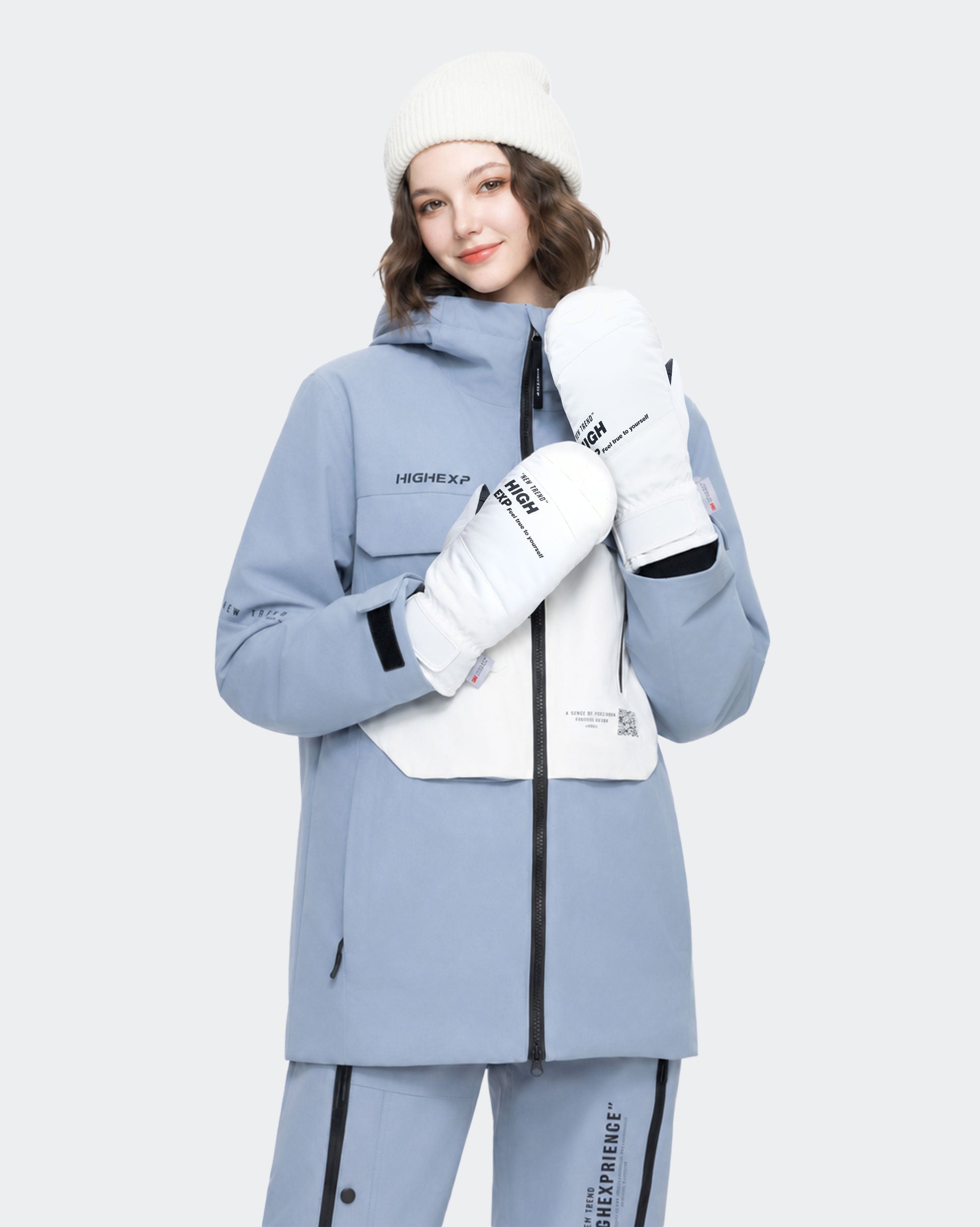 High Experience Black White Ski Gloves - Female Model Wearing Grey Blue Ski Jacket for Winter Sports