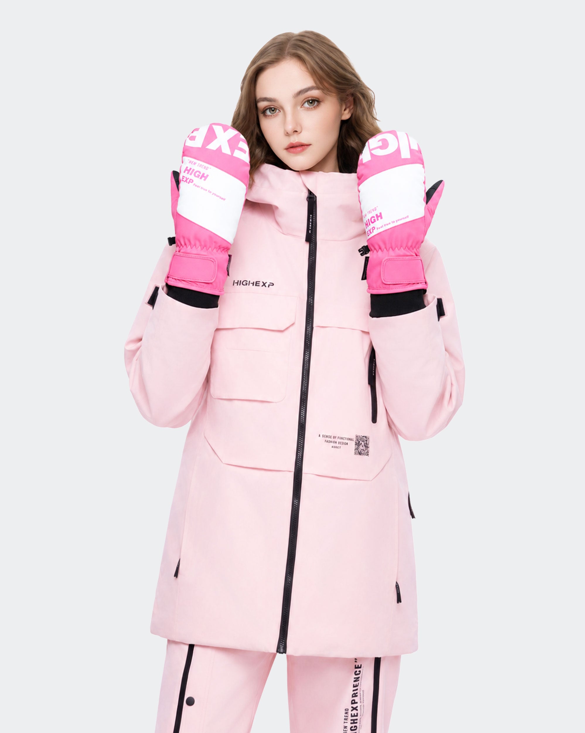 High Experience Pink Ski Gloves - Female Model in Pink Ski Outfit, Side Angle