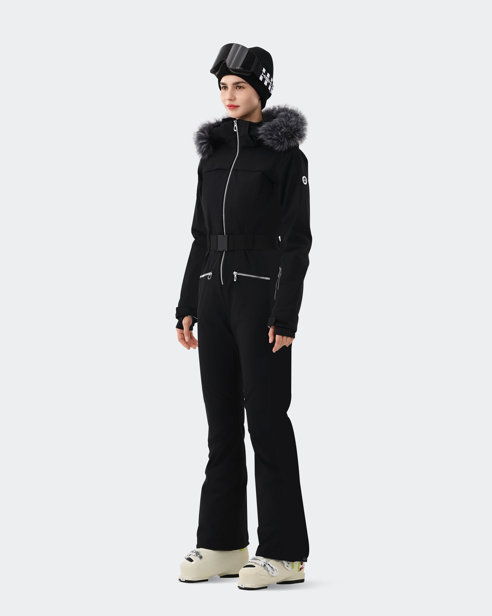 Black one-piece ski suit side view showing slim waist belt and finger hole cuffs
