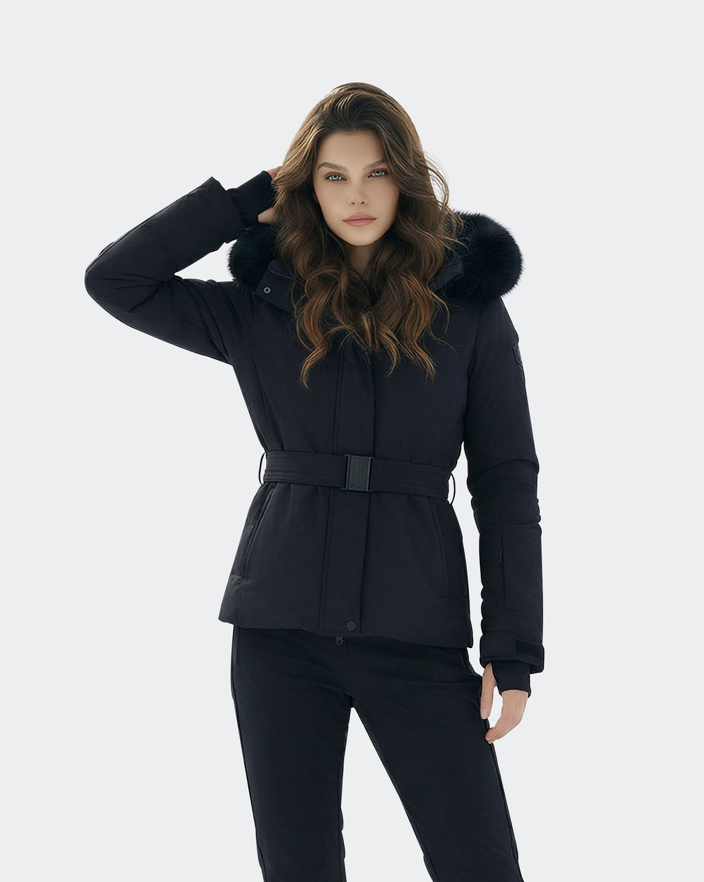 Black women's ski jacket side view showing slim silhouette and waist belt
