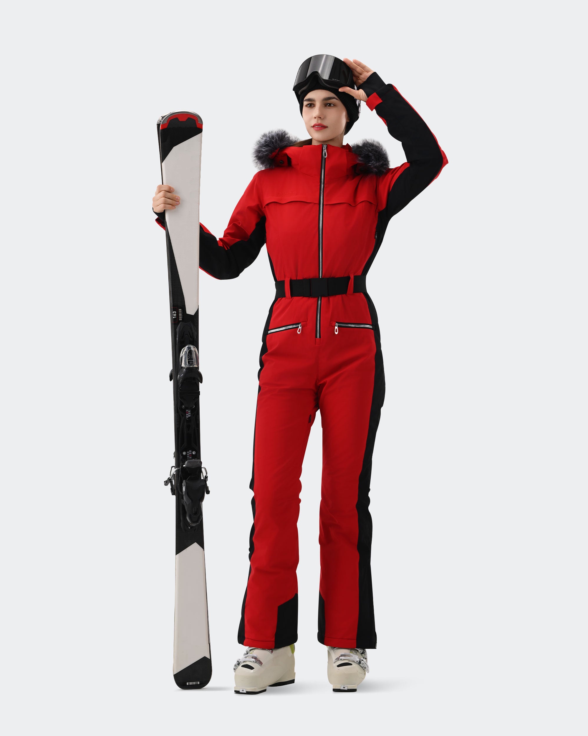Women wearing Red and Black one-piece insulated ski suit powder day
