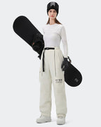 HIGH EXPERIENCE Women's Baggy Ski Pants Cream White On Model with Board — Waterproof Ski Pants