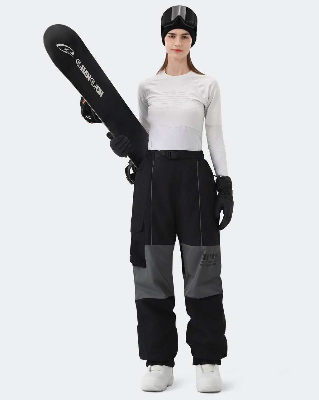 HIGH EXPERIENCE Women's Baggy Ski Pants Black On Model with Board — Waterproof Snowboard Pants