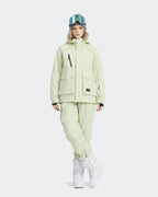 Women wearing Sage Color waterproof ski jacket outdoor action shot
