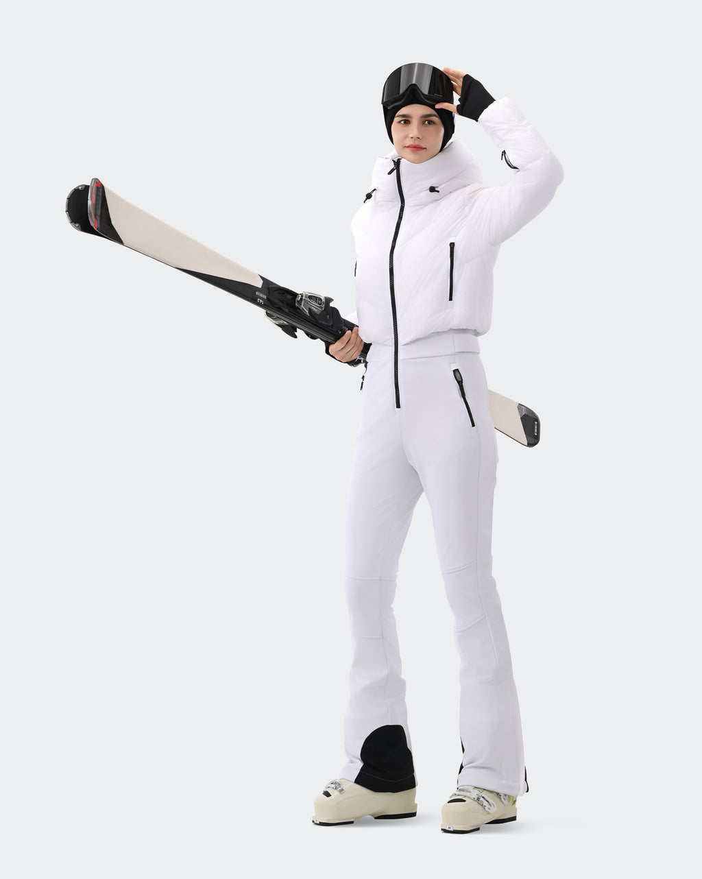 Woman wearing White one-piece insulated ski suit outdoor lifestyle shot
