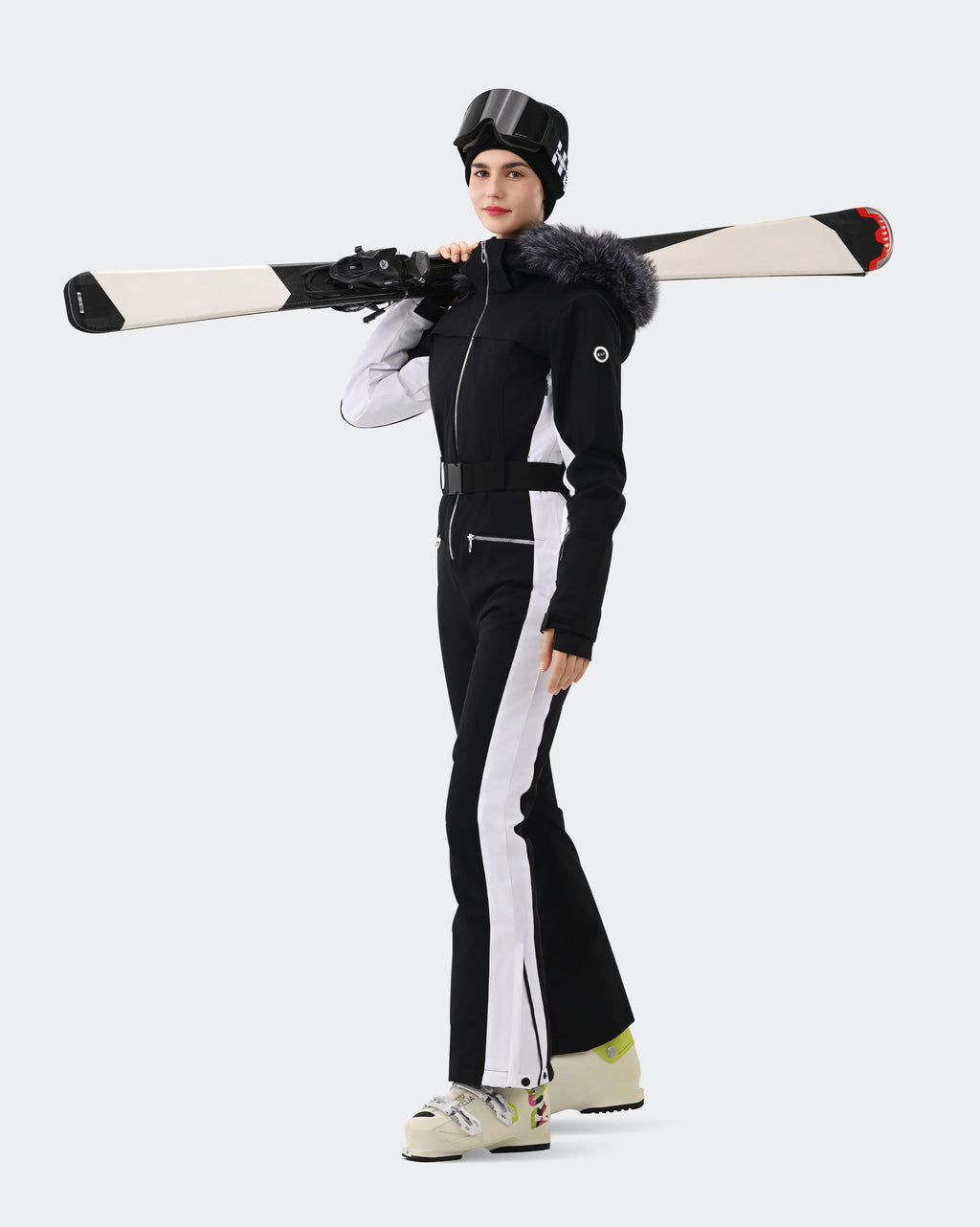 Women wearing Black White one-piece waterproof ski suit on slopes
