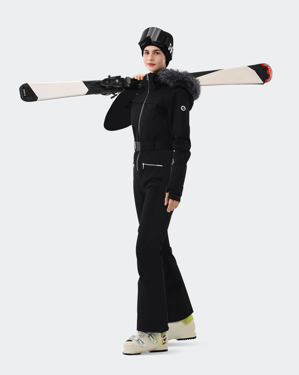 Women wearing Black one-piece insulated ski suit on mountain
