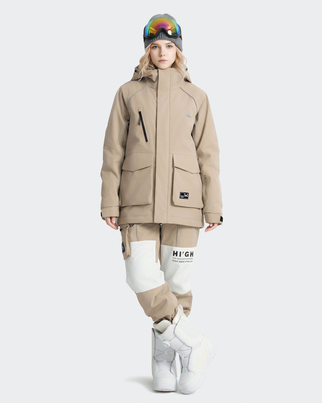 Women wearing Light Khaki snowboard jacket lifestyle shot on mountain
