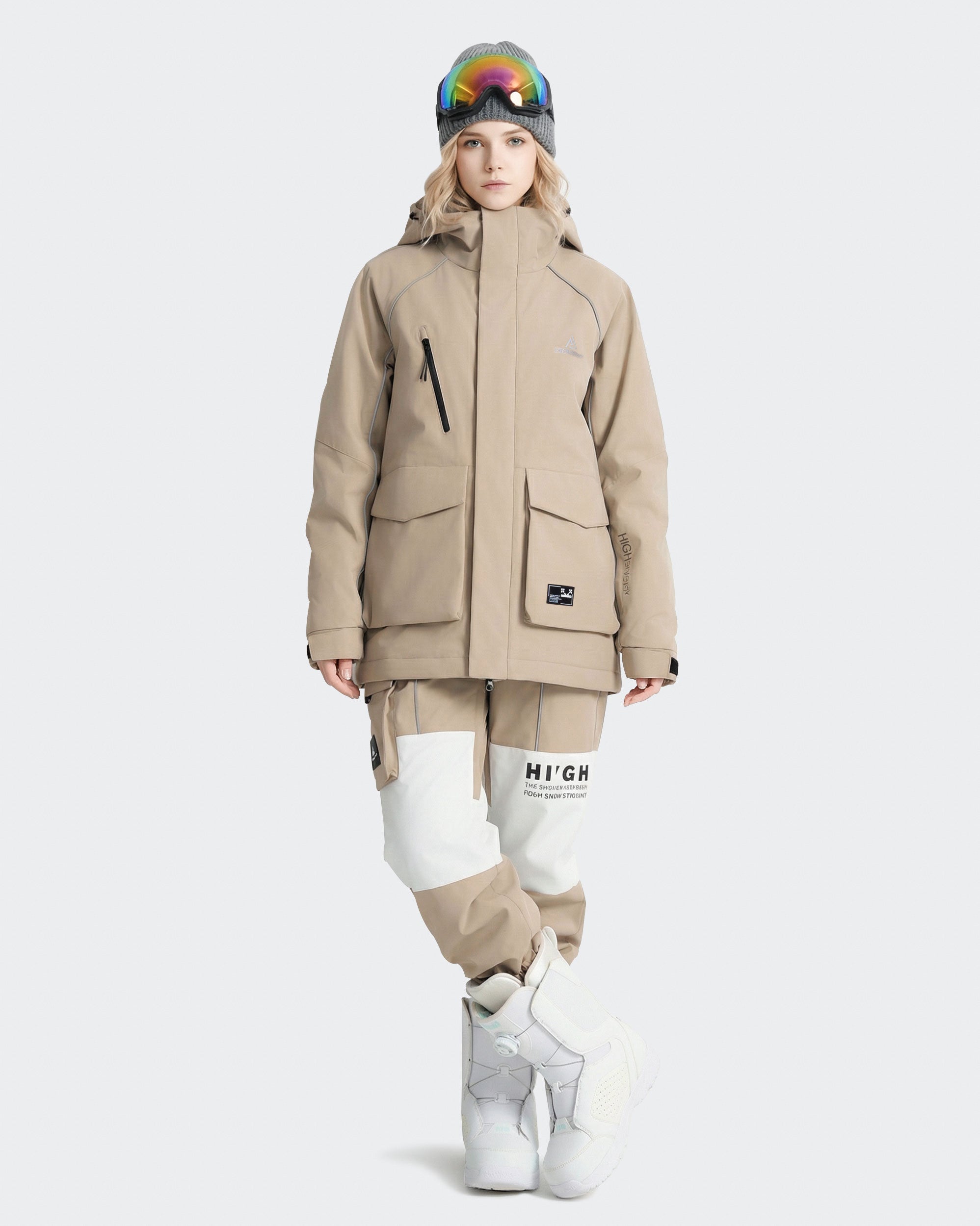 Women wearing Light Khaki snowboard jacket lifestyle shot on mountain
